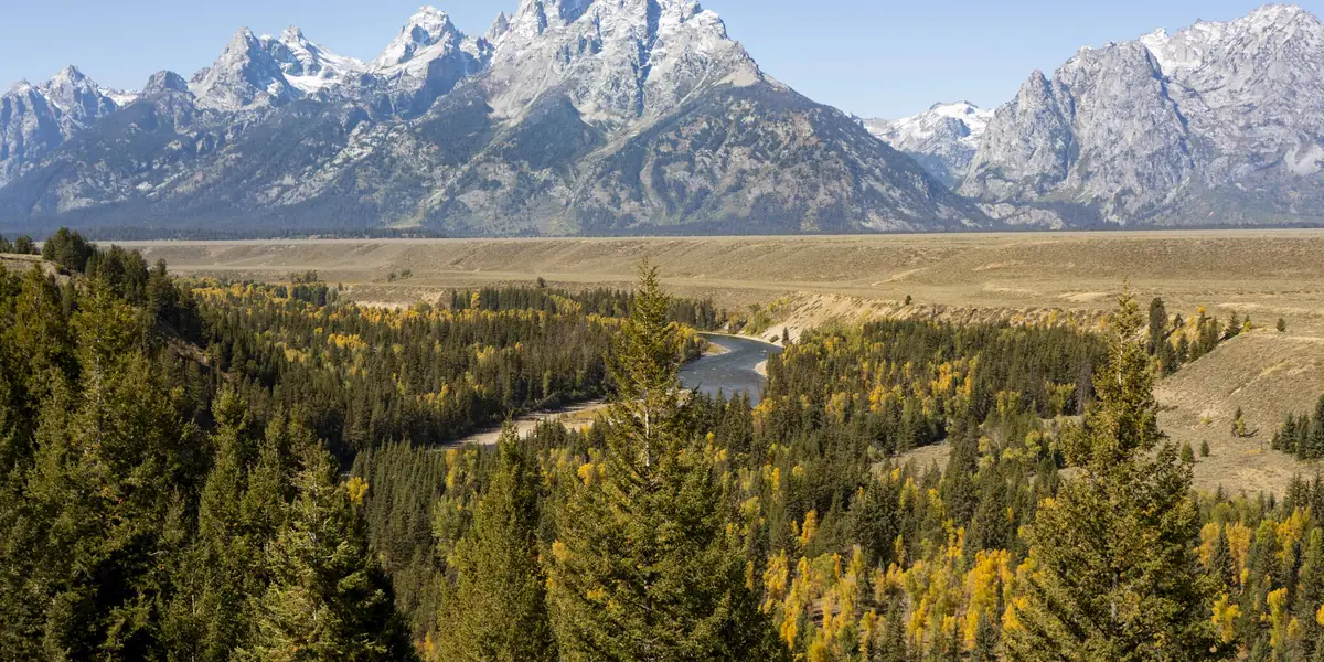 Teton Range above autumn forest along the Snake River, Grand Teton National Park, Wyoming